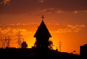 Sunset over the town with church tower, Tulcea, Romania.